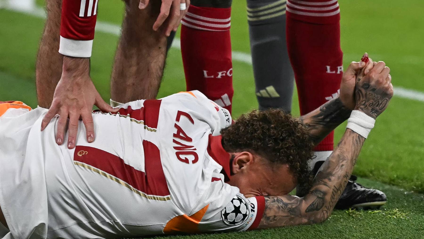 Galatasaray's Dutch forward #77 Noa Lang reacts on the floor after cutting his thumb during the UEFA Champions League, round of 16 second leg football match between Liverpool and Galatasaray at Anfield in Liverpool, north-west England on March 18, 2026.