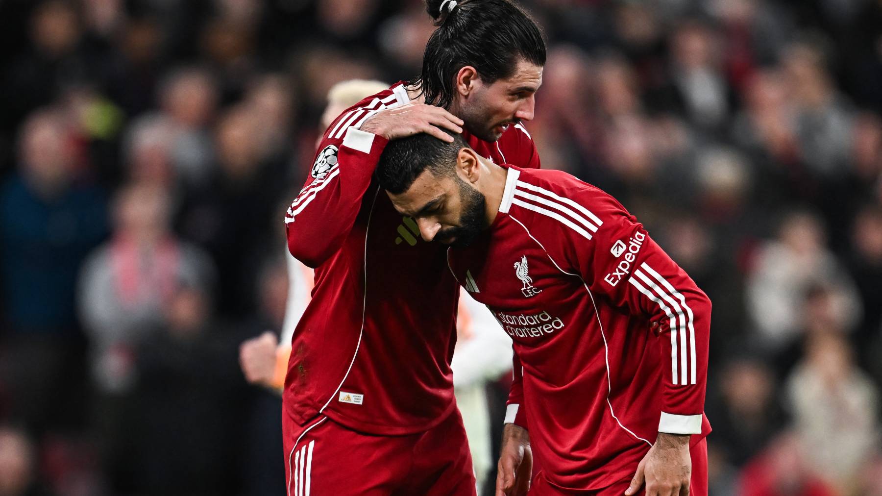 Liverpool's Hungarian midfielder #08 Dominik Szoboszlai (L) greets Liverpool's Egyptian forward #11 Mohamed Salah before a penalty kick during the UEFA Champions League, round of 16 second leg football match between Liverpool and Galatasaray at Anfield in Liverpool, north-west England on March 18, 2026.